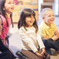 Seated children listening and smiling