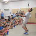 A comedy juggler performing for a crowd
