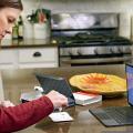 Woman taking COVID test in kitchen with laptop in front of her
