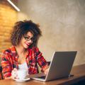 Woman enjoying what she sees on her laptop