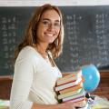 Teacher in her classroom with books