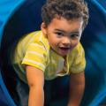 Child exiting a play tunnel