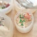 Three resin molds setting with craft supplies inside.
