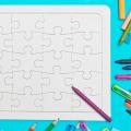 Colored pencils and a blank jigsaw puzzle