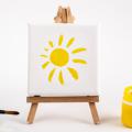 Paint, paintbrushes, canvas and easel