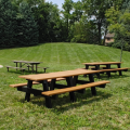 Three picnic tables in the grass
