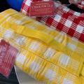 Red and yellow gingham picnic blankets with "Check Me Out" tags