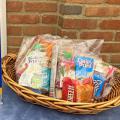 Snack bags in a basket next to Snacks for kids and teens pickup sign