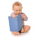 Baby playing with book