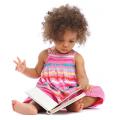 Toddler girl holding a book