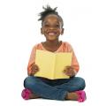 Girl holding a book and smiling