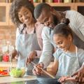 Two adults and a child preparing a meal