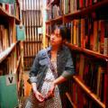 Amanda K standing between book shelves