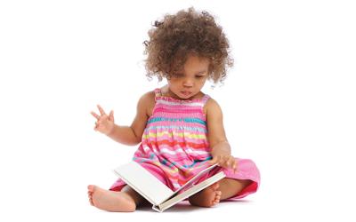 Toddler sitting with a book in her lap