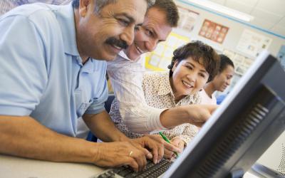 Adults working on a computer