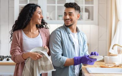 Man and woman washing and drying dishes