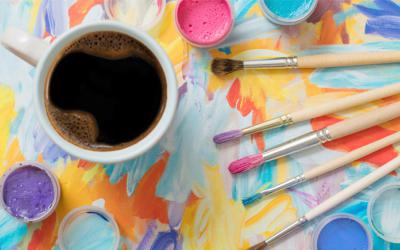 Mug of coffee, paint brushes, paints