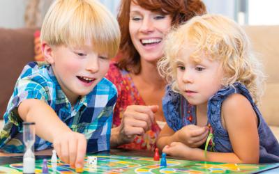 Children and parent playing a board game