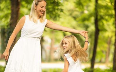 Woman and child dancing outdoors