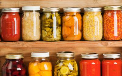 Two rows of canned vegetables on shelves