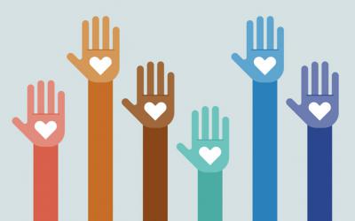Raised hands of different colors have hearts on their palms