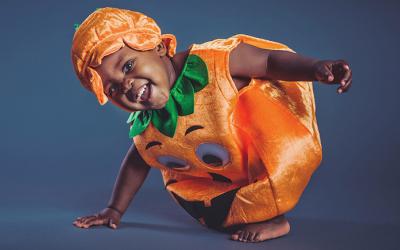 Child wearing a jack o'lantern costume