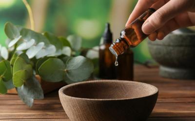 Hand holds a bottle dropping liquid into bowl