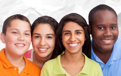 Four teens in brightly colored shirts