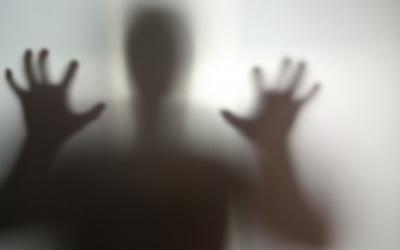Mysterious silhouette with hands outstretched