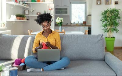 Woman with a laptop knitting