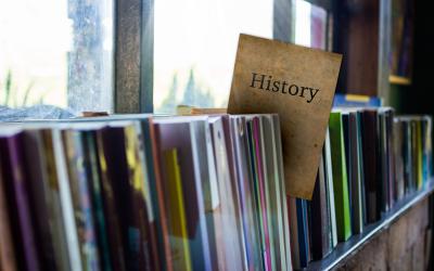 Books on shelf with a History label