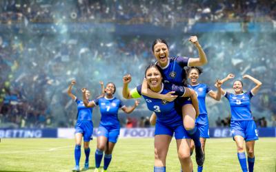 Women's soccer team celebrates in crowded stadium