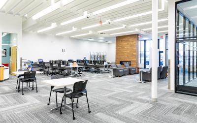 Computers, tables and chairs and fireplace area