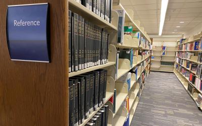 Reference sign in foreground, with bookshelves stretching off in the background