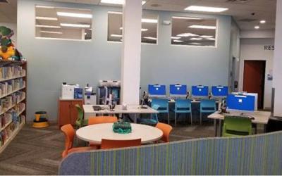 Tween area with tables and chairs, computers and printer