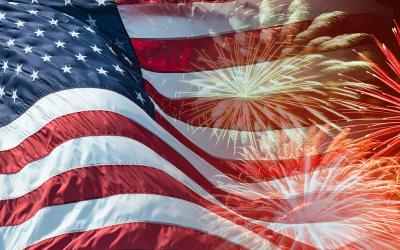 Waving American flag with fireworks