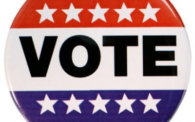 A red, white and blue "vote" button