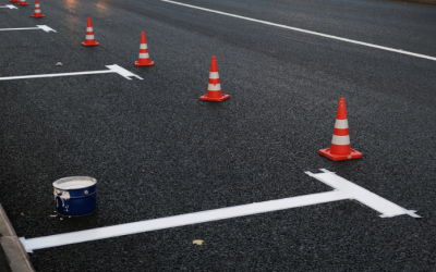 A parking lot with orange traffic cones that is currently undergoing repairs.