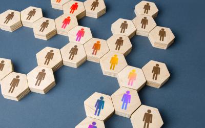 Wooden hexagonal tiles with a person icon on them in different colors
