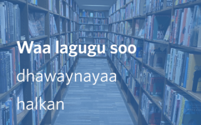 Bookshelves with text that reads Waa lagugu soo dhawaynayaa halkan