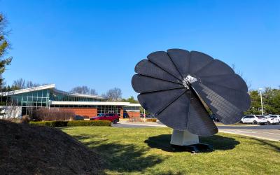 Smartflower solar panels in front of Northwest Library on a sunny day