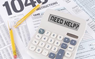 1040 tax forms with calculator and broken pencil