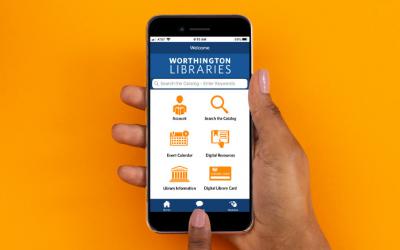 Hand holding smartphone with Worthington Libraries mobile app