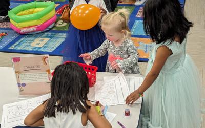 Children in dresses with crown craft