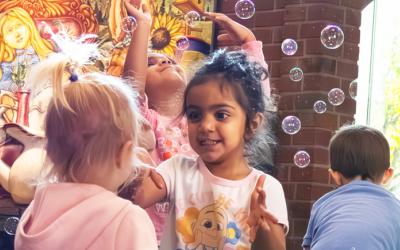 Children playing among bubbles at Northwest Library
