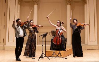 Members of Carpe Diem String Quarter in formal wear on stage
