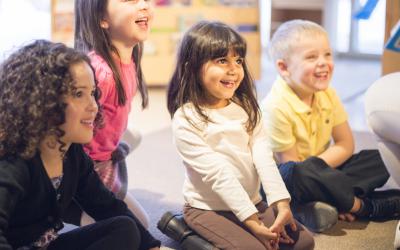 Seated children listening and smiling