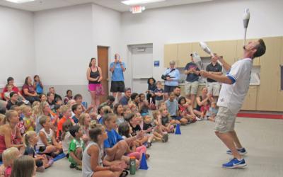 A comedy juggler performing for a crowd