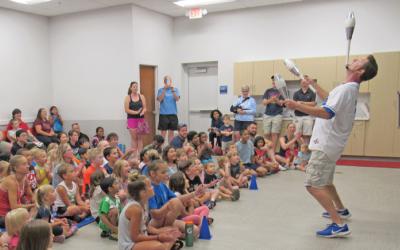 A comedy juggler performing for a crowd
