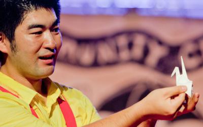 Yasu Ishida telling stories with an origami bird